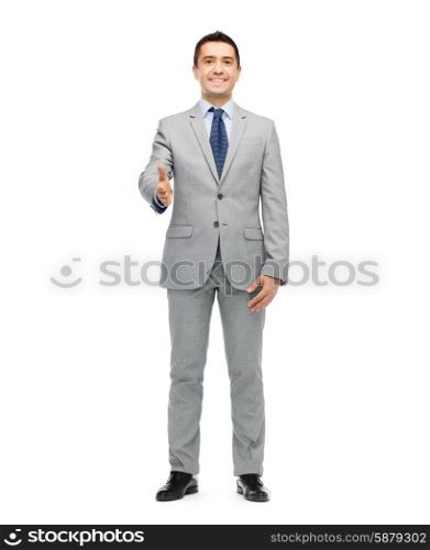 business, people, gesture, partnership and greeting concept - happy smiling businessman in suit shaking hand
