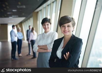 business people group, females as team leaders standing together in modern bright office interior