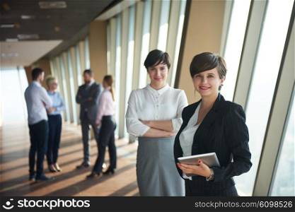 business people group, females as team leaders standing together in modern bright office interior