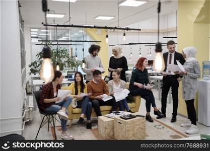 business people group in modern office have a team meeting and brainstorming while working on tablet or laptop presenting ideas and take notes
