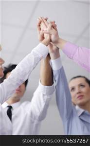 business people group joining hands and representing concept of friendship and teamwork, low angle view