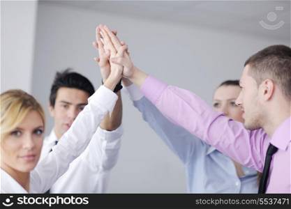 business people group joining hands and representing concept of friendship and teamwork, low angle view