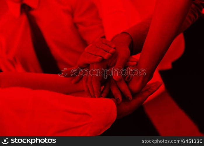 business people group joining hands and representing concept of friendship and teamwork, low angle view