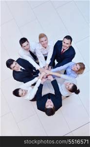 business people group joining hands and stay as team in circle and representing concept of friendship and teamwork