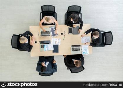 Business people group meeting shot from top view in office . Profession businesswomen, businessmen and office workers working in team conference with project planning document on meeting table .