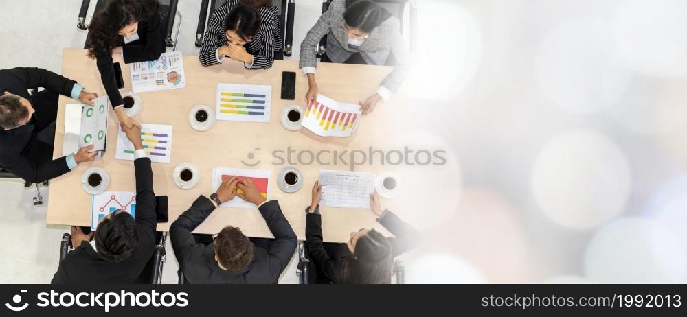 Business people group meeting shot from top view in office . Profession businesswomen, businessmen and office workers working in team conference with project planning document broaden view .. Business people group meeting shot from top view broaden view