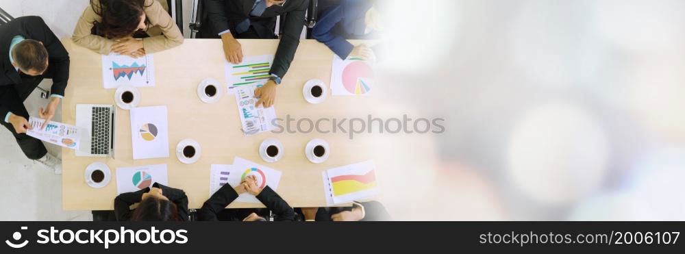 Business people group meeting shot from top view in office . Profession businesswomen, businessmen and office workers working in team conference with project planning document broaden view .. Business people group meeting shot from top view broaden view