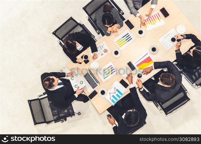 Business people group meeting shot from top view in office . Profession businesswomen, businessmen and office workers working in team conference with project planning document on meeting table .