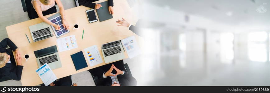 Business people group meeting shot from top widen view in office . Profession businesswomen, businessmen and office workers working in team conference with project planning document on meeting table .. Business people group meeting shot from top widen view