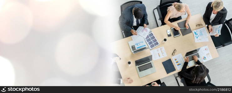 Business people group meeting shot from top widen view in office . Profession businesswomen, businessmen and office workers working in team conference with project planning document on meeting table .. Business people group meeting shot from top widen view