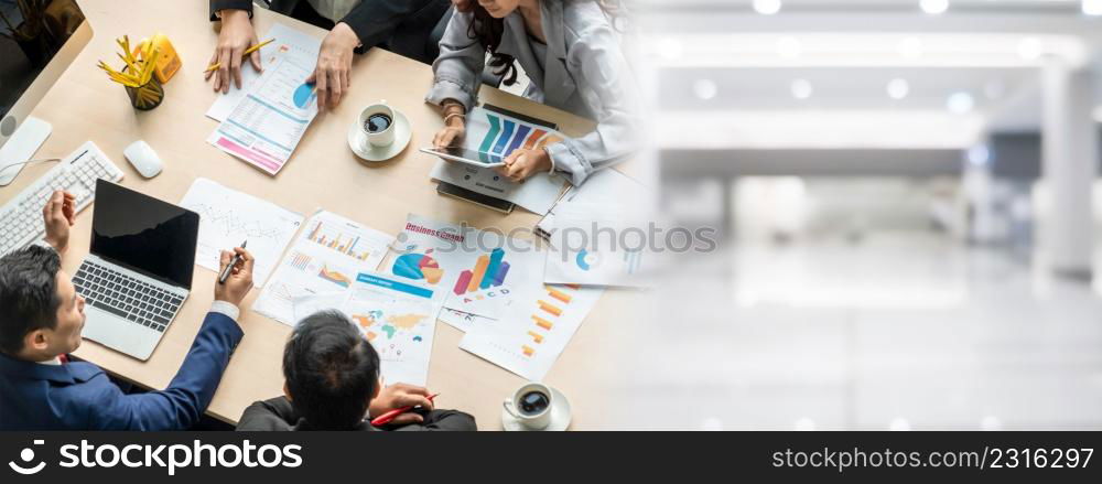 Business people group meeting shot from top widen view in office . Profession businesswomen, businessmen and office workers working in team conference with project planning document on meeting table .. Business people group meeting shot from top widen view