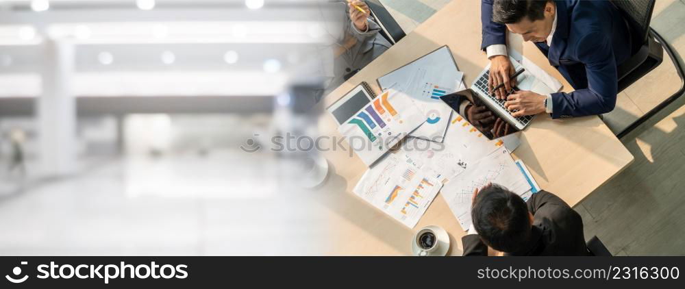 Business people group meeting shot from top widen view in office . Profession businesswomen, businessmen and office workers working in team conference with project planning document on meeting table .. Business people group meeting shot from top widen view