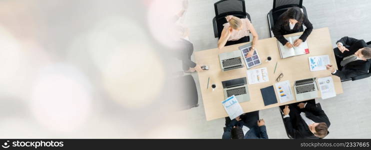 Business people group meeting shot from top widen view in office . Profession businesswomen, businessmen and office workers working in team conference with project planning document on meeting table .. Business people group meeting shot from top widen view