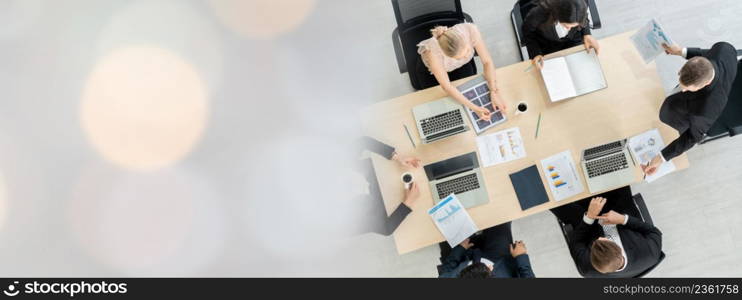 Business people group meeting shot from top widen view in office . Profession businesswomen, businessmen and office workers working in team conference with project planning document on meeting table .. Business people group meeting shot from top widen view