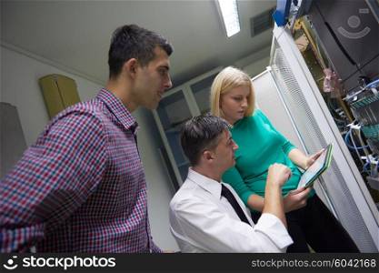 business people group, network engeneers working in network server room on tablet computer