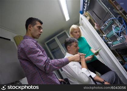 business people group, network engeneers working in network server room on tablet computer