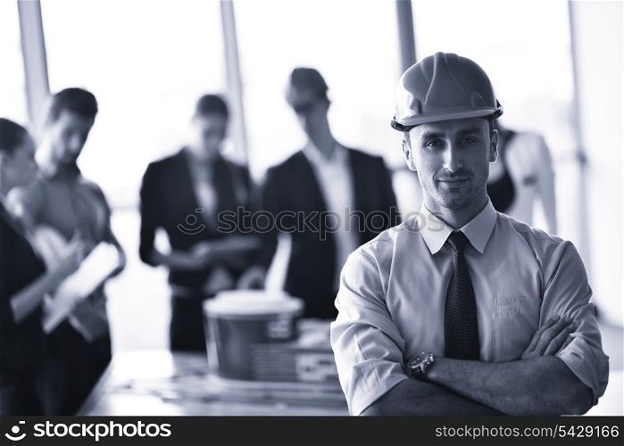 business people group on meeting and presentation in bright modern office with construction engineer architect and worker looking building model and blueprint planbleprint plans