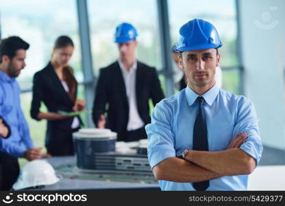 business people group on meeting and presentation in bright modern office with construction engineer architect and worker looking building model and blueprint planbleprint plans