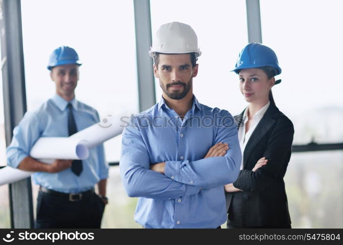 business people group on meeting and presentation in bright modern office with construction engineer architect and worker looking building model and blueprint planbleprint plans