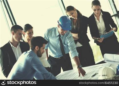 business people group on meeting and presentation in bright modern office with construction engineer architect and worker looking building model and blueprint planbleprint plans