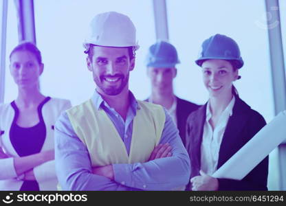 business people group on meeting and presentation in bright modern office with construction engineer architect and worker looking building model and blueprint planbleprint plans