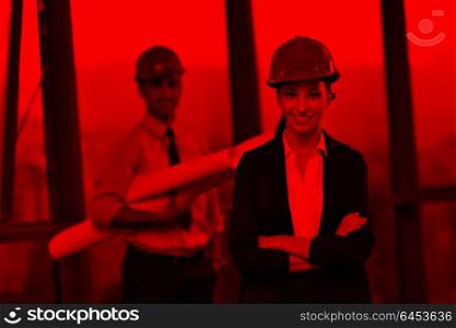 business people group on meeting and presentation in bright modern office with construction engineer architect and worker looking building model and blueprint plans