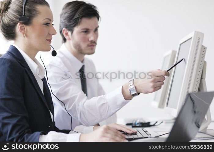 business people group with headphones giving support in help desk office to customers, manager giving training and education instructions