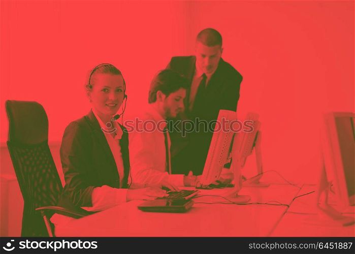 business people group with headphones giving support in help desk office to customers, manager giving training and education instructions duo tone