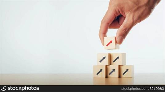 Business people hand stacked wooden blocks in stages Startup business concept Up arrow Success business growth process idea