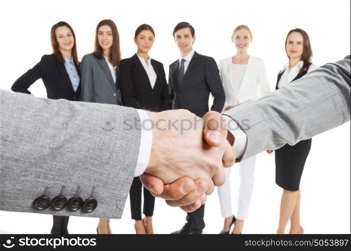 Business people handshake. Business people handshake over team of people isolated on white background
