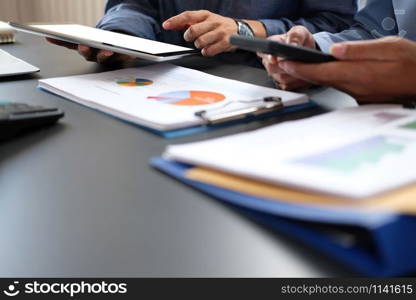 business people have a meeting. businessman using tablet smart phone working on performance revenue with co-worker team.