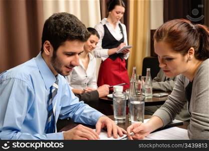 Business people having a company meeting at restaurant waitress ordering