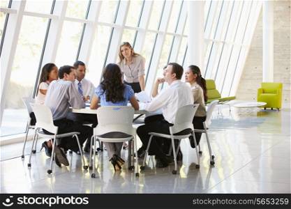 Business People Having Board Meeting In Modern Office