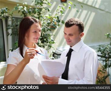 business people having discussion and working with papers outdoors
