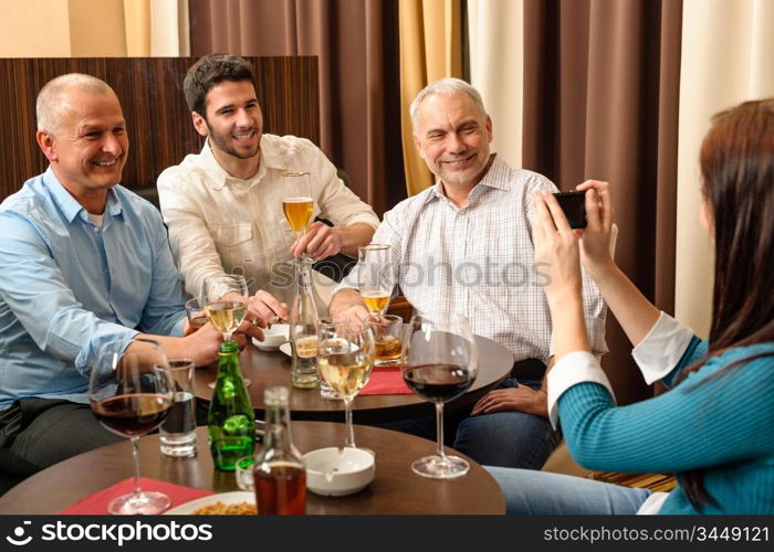 Business people having drink after work taking picture of themselves