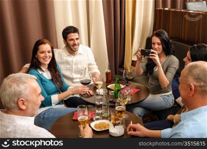 Business people having drink after work taking picture of themselves