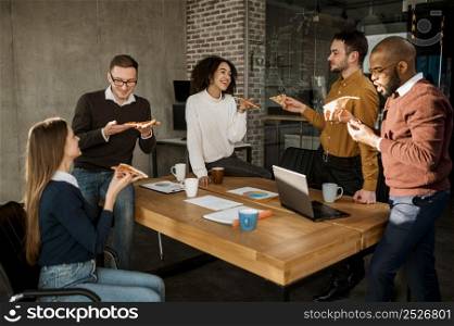 business people having pizza during office meeting break