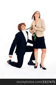 Business people - he is kneeling in front of her and she is pulling him on this tie