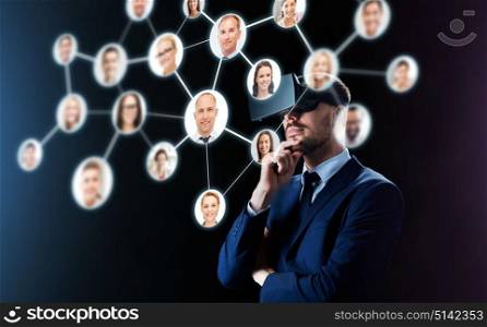 business, people, headhunting, augmented reality and modern technology concept - businessman in virtual headset looking at contacts network over black background. businessman in virtual reality headset over black