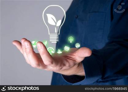 Business people holding energy-saving lamps. The work includes environmentally friendly energy source icons, energy saving ideas, and environmentally friendly campaigns.. Business people holding energy-saving lamps. The work includes environmentally friendly energy source icons.