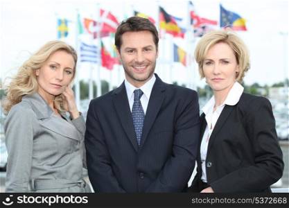 Business people in front of flags