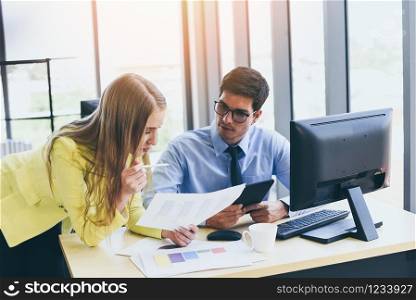 Business people in meeting discussing about financial results in office room / Business team working project together on the desk , Partner colleagues are talking in the document report chart graph
