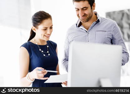 Business people in modern office. Business people working and discussing in modern office