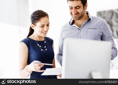 Business people in modern office. Business people working and discussing in modern office