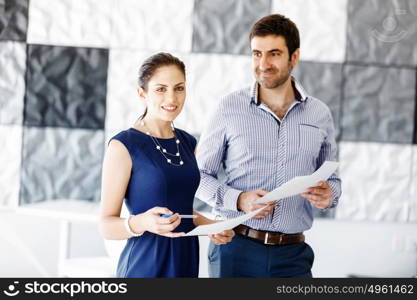 Business people in modern office. Business people working and discussing in modern office