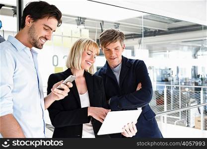 Business people in office looking at digital tablet