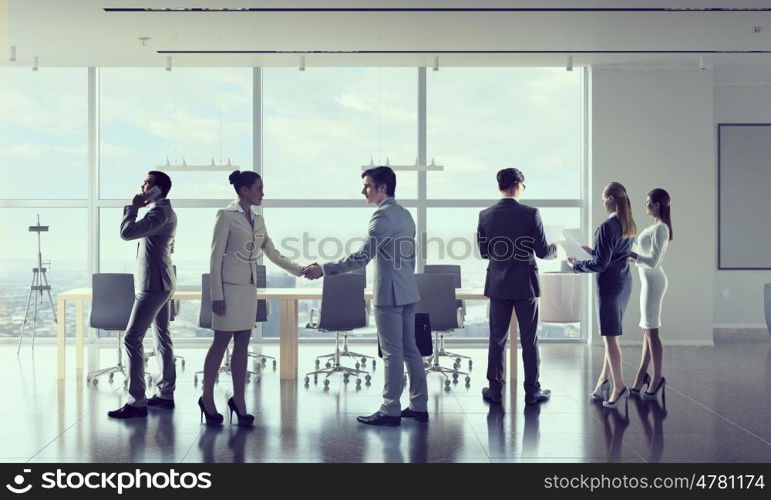 Business people in office mixed media. Business people in modern office interior working in cooperation