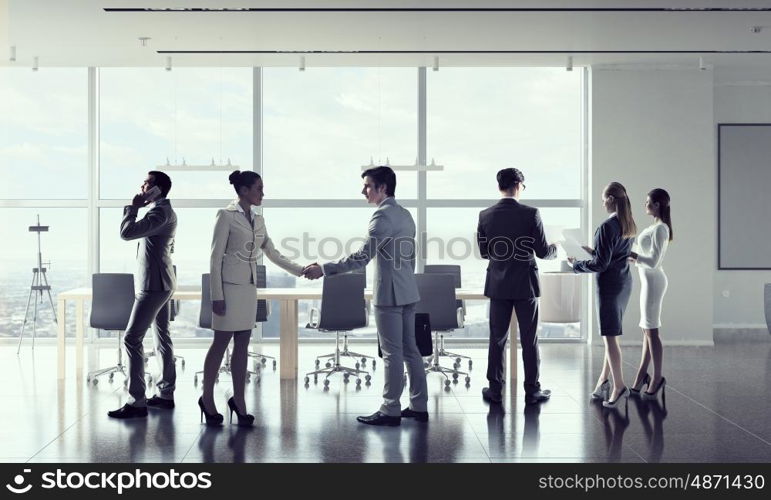 Business people in office mixed media. Business people in modern office interior working in cooperation