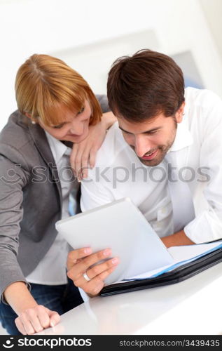 Business people in office using electronic tablet