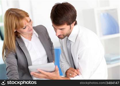 Business people in office using electronic tablet